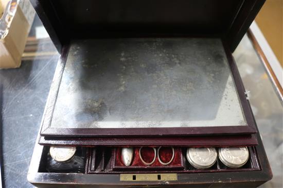 A Victorian brass mounted rosewood toilet box, containing four silver mounted bottles and four nail implements, box 28cm.